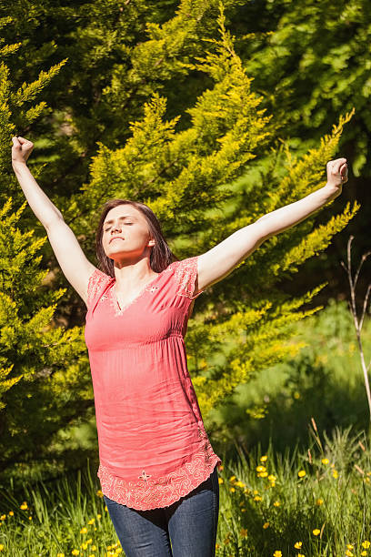 istock Pretty brunette stretching and enjoying the sunshine 460921113