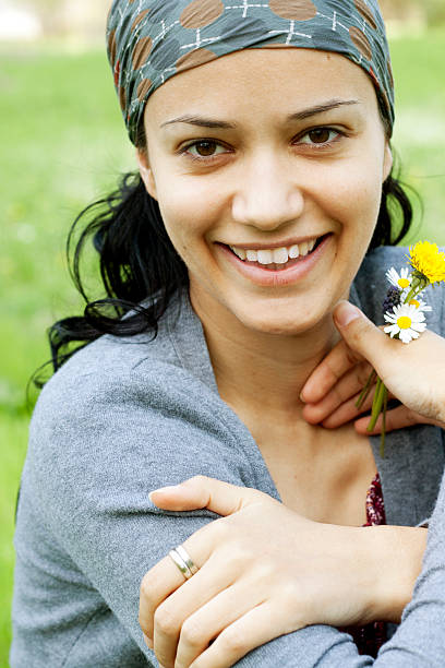 istock smiling woman holding wildflowers 460924539