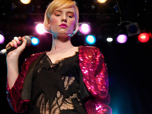 istock Young Woman Singing In Concert 460930087