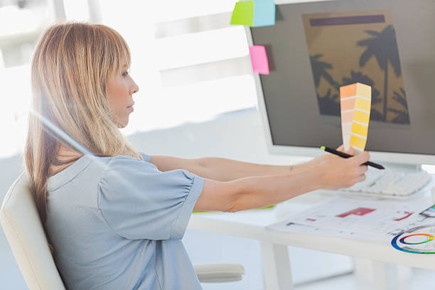 istock Interior designer comparing a photo with colour charts 460930459