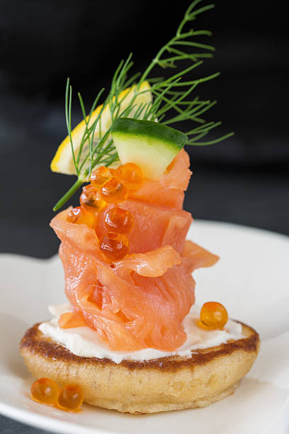 istock Single Blini appetizer with smoked salmon, caviar and sour cream 460938715