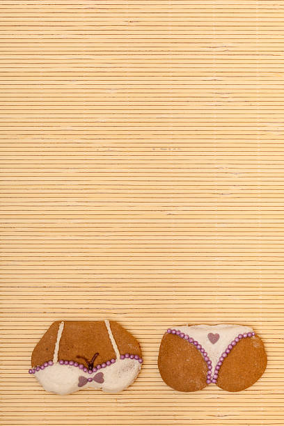 istock Yellow pink bikini shape gingerbread cake cookie on bamboo mat 460939191
