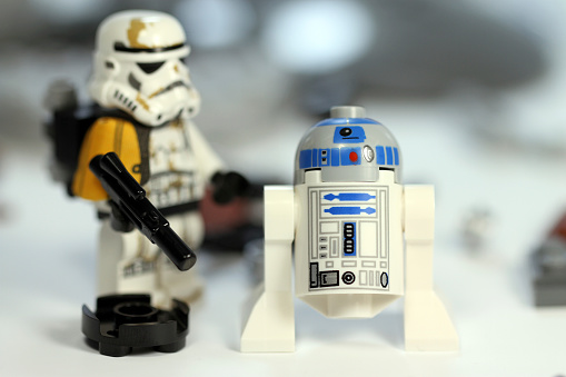 Vancouver, Canada - February 26, 2013: A lego Sandtrooper and droid from the Star Wars film franchise against a background of wreckage.