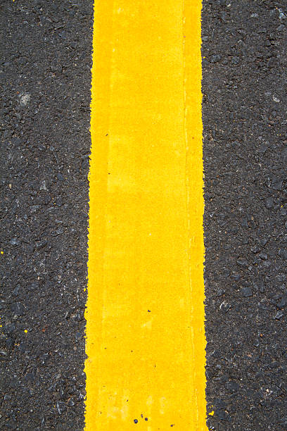 istock yellow line on the road texture background 461001477