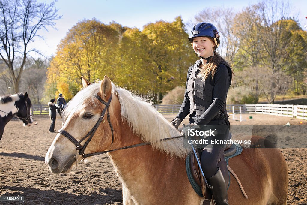 Young girl riding horse Portrait of teenage girl riding horse outdoors on sunny autumn day Learning Stock Photo