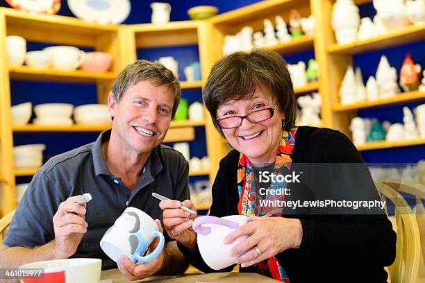 Happy Retired Couple Painting Pottery Stock Photo - Download Image Now - Painting - Activity, Pottery, 40-49 Years