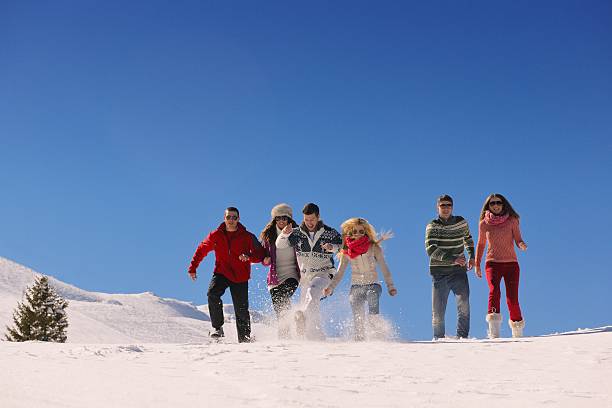 istock friends have fun at winter on fresh snow 461025445