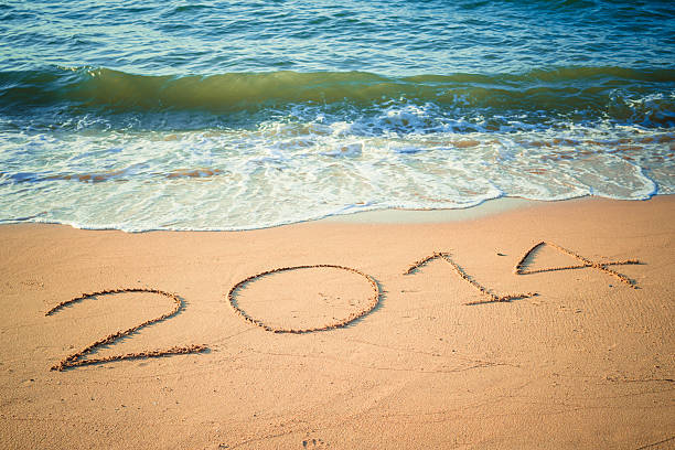 istock Writing Happy New Year's 2014 on the Beach in Thailand 461027555