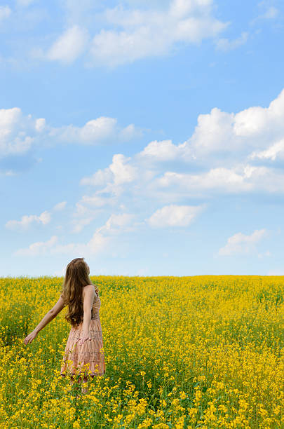 istock Young woman at canola field 461032379