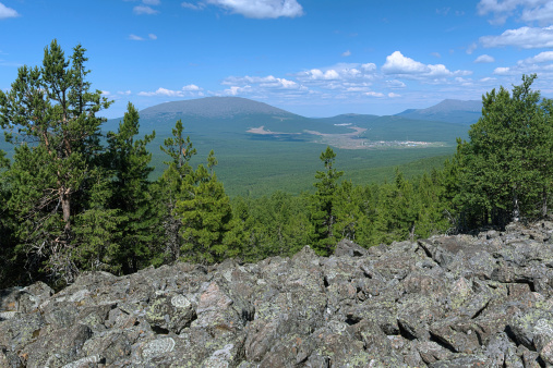 Northern Ural Mountains, View from the slope of Third Bugor Mount on mountains Kosvinsky Rock and Konzhakovsky Rock and Kytlym settlement, Russia