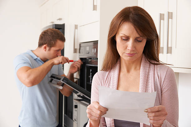 istock Woman Looking Concerned At Repair Bill 461037991