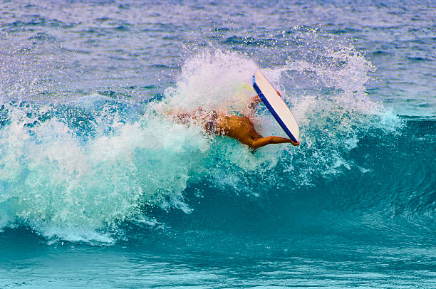 istock Young man boogie boarding, Maui, Hawaii, USA 461051873