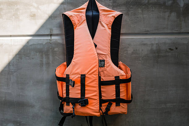 Hanging old life saving vest Hanging old life saving vest life jacket stock pictures, royalty-free photos & images