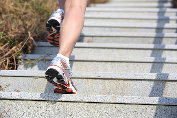 istock woman running up on mountain stairs 461057531