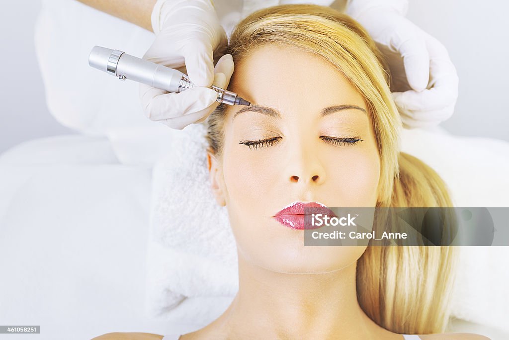 Permanent make up on eyebrows Cosmetologist applying permanent make up on eyebrows Permanent Make-Up Stock Photo