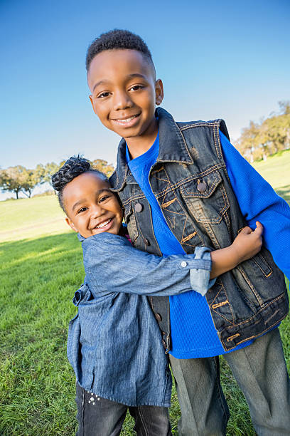 istock Happy African American siblings spending time together at park 461060603