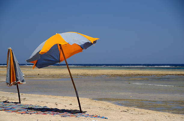 istock two colorful umbrellas at sea 461063949