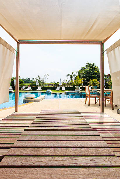 istock Sunbeds chair and swimming pool 461065189