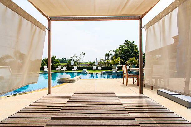 istock Sunbeds chair and swimming pool 461065197