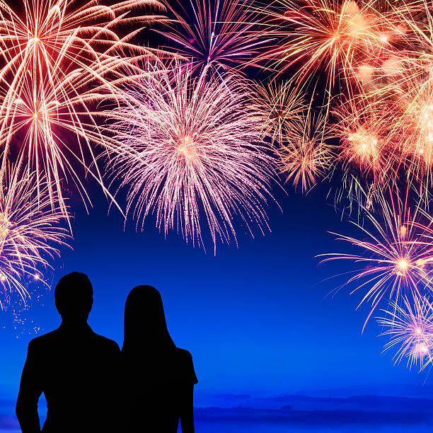 istock Couple enjoying a fireworks display 461066297