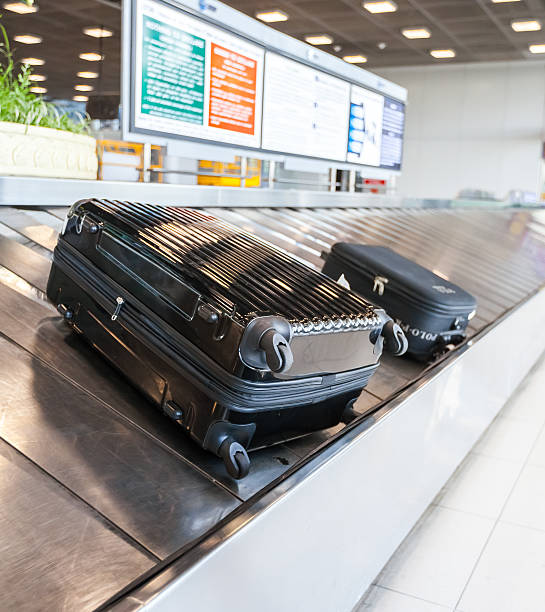 istock Baggage on conveyor belt at the airport 461083239