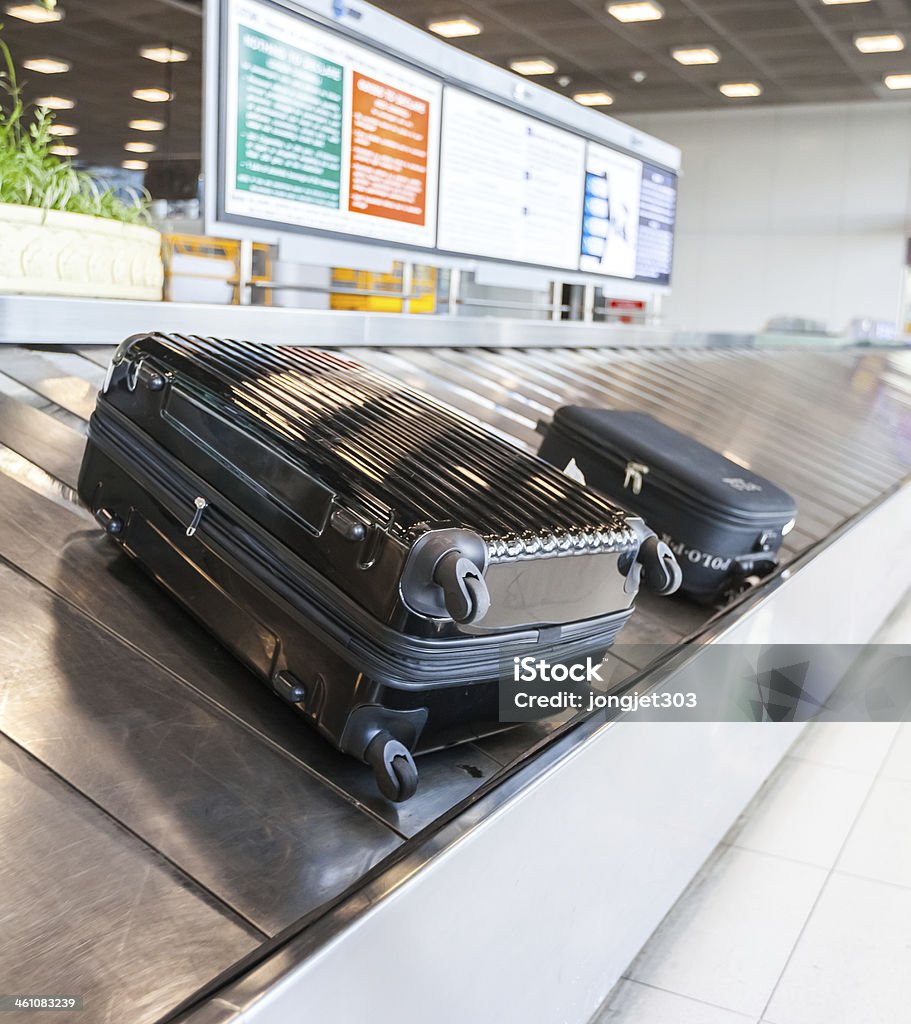 Baggage on conveyor belt at the airport Baggage Claim Stock Photo