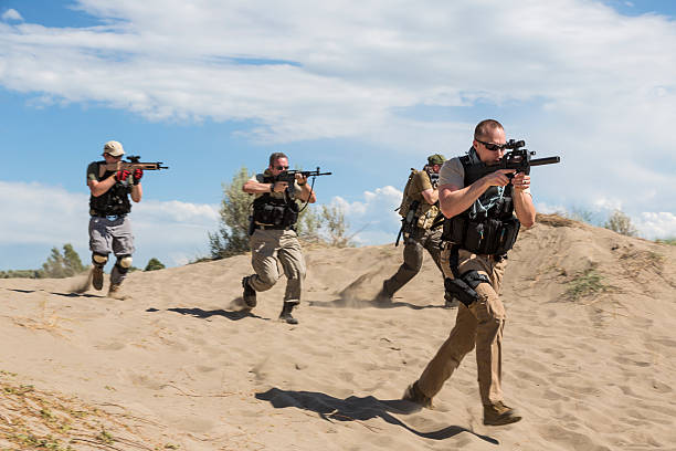 Group of special forces soldiers advancing with weapons drawn