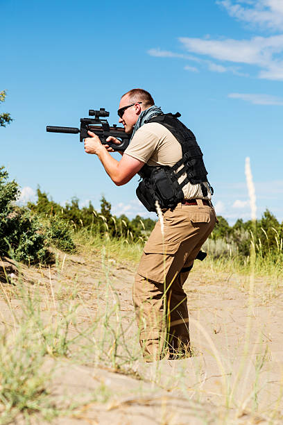 istock Special Operations soldier taking aim on patrol in desert landscape 461087559