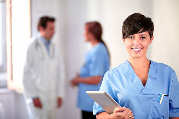 istock Lovely latin nurse on blue uniform standing 461091297