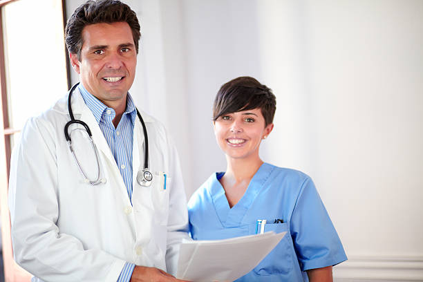 istock Handsome doctor and beautiful nurse smiling 461092969