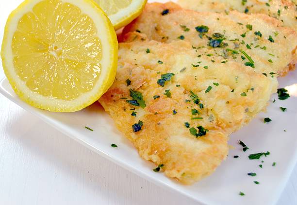 istock Fish cooked with parsley and lemon 461100259