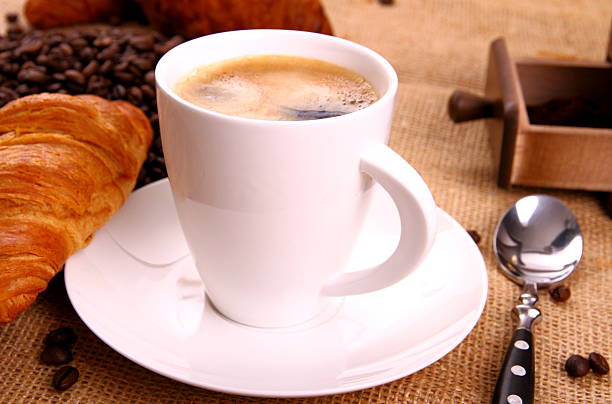 istock Coffee in white cup and croissant 461105067