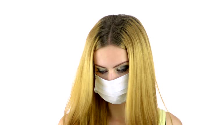 Coughing girl puts a face mask