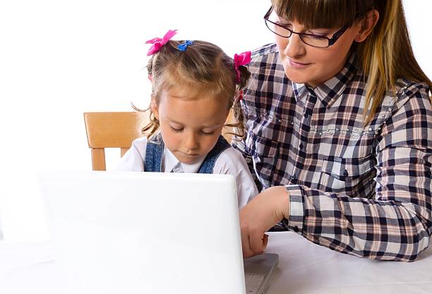 istock mother and daughter with mobile phone 461108589