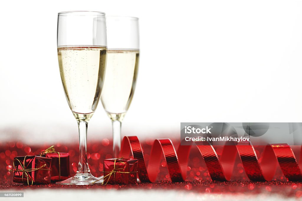 Champagne and gifts Champagne and holiday gifts on red glitter background Alcohol - Drink Stock Photo