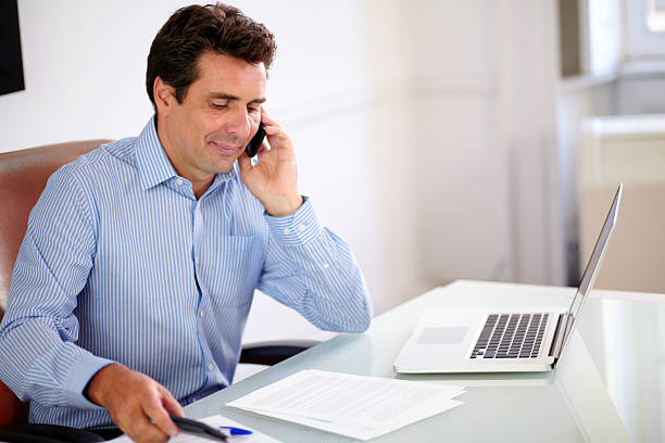 istock Attractive businessman talking on his cellphone 461122103