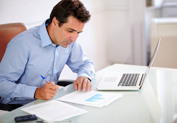 istock Adult hispanic businessman looking at his notes 461125835