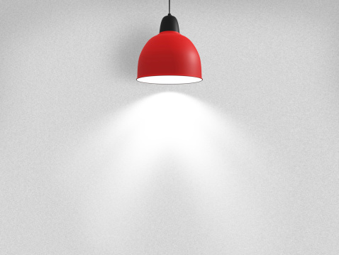 Empty wall with white spotlight in red lamp.