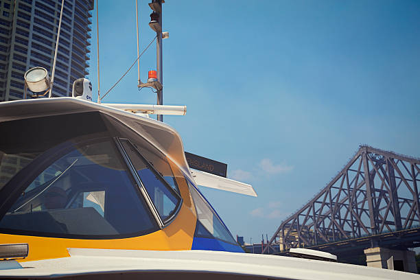Brisbane, Australia - January 1, 2014: Brisbane CityCat Captain on clear day with Story Bridge in background.