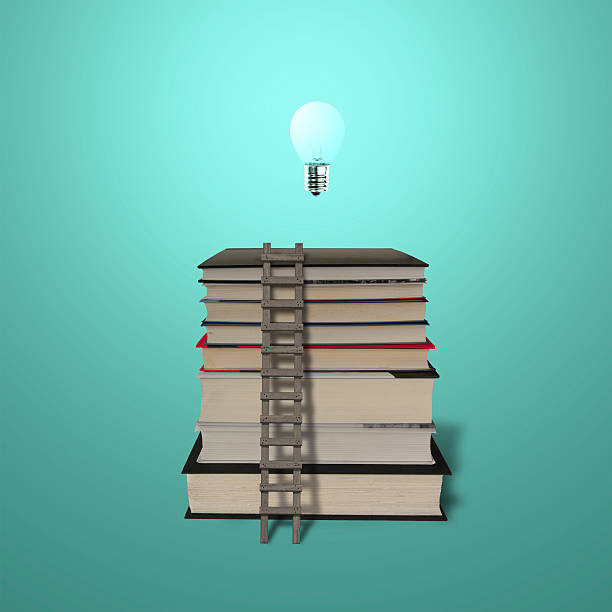 istock Glowing lamp on top of stack books with wooden ladde 461144597