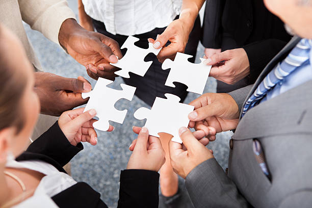 istock Businesspeople Holding Jigsaw Puzzle 461149123