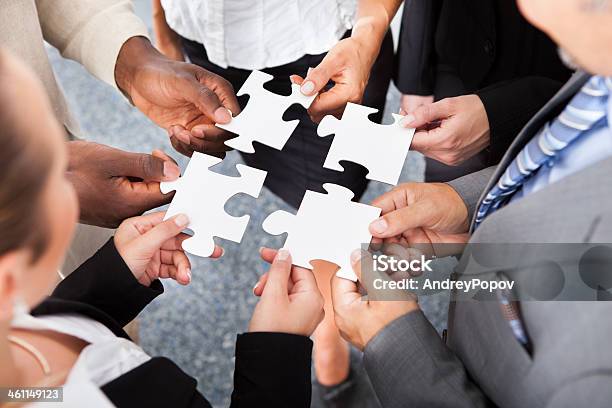 Businesspeople Holding Jigsaw Puzzle Stock Photo - Download Image Now - Above, Adult, African Ethnicity