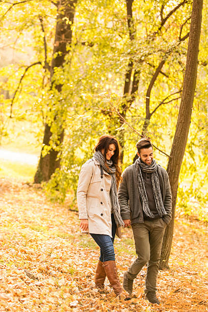 istock Smiling couple walking in the park 461162171