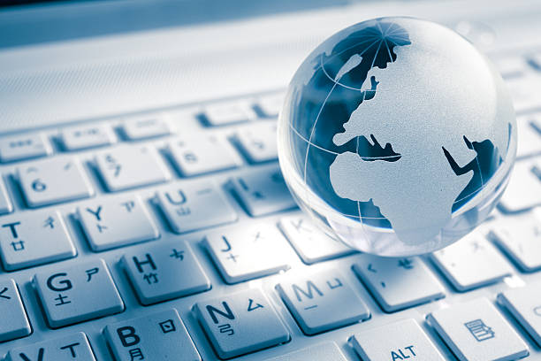 istock White planet globe above a white international keyboard 461164161