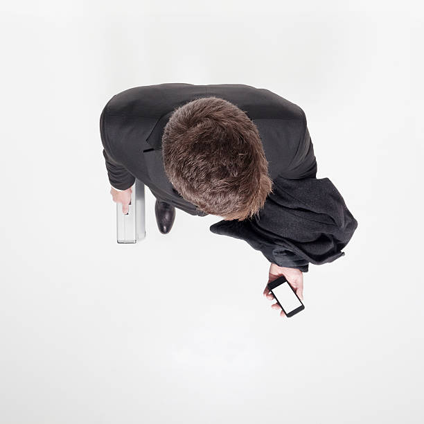 istock Above of businessman holding mobile and briefcase 461164475