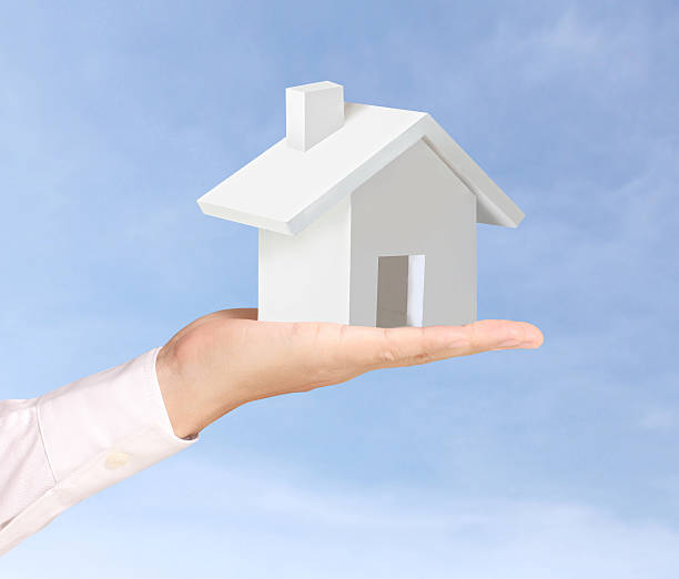 istock holding house representing home ownership 461170299