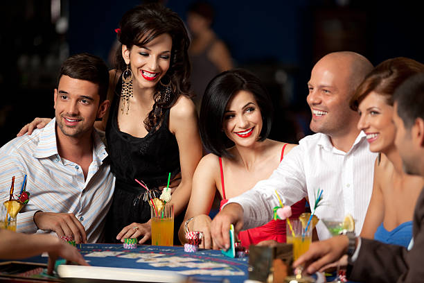 laughing friends playing cards in casino happy player and friends playing blackjack poker card game stock pictures, royalty-free photos & images