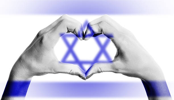 istock Israeli flag over heart-shaped human hands on isolated background 461172975