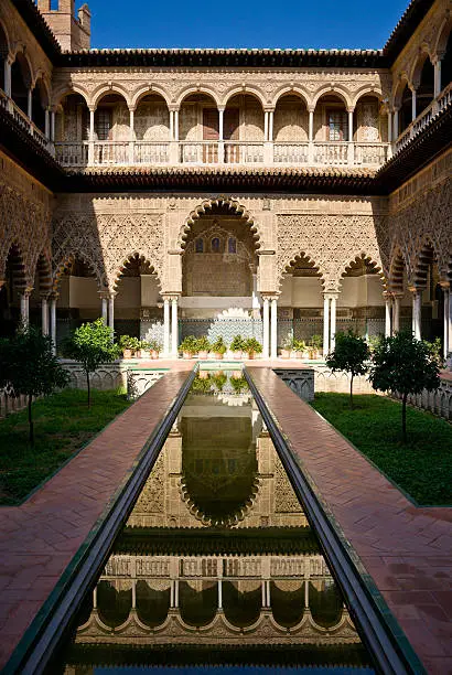 The lower level of the Patio was built for King Peter I in 1364 as a royal residence. The name "Courtyard of the Maidens" (Patio de las Doncellas) refers to the legend that the Moors demanded hundred virgins every year as tribute from Christian kingdoms in Iberia.