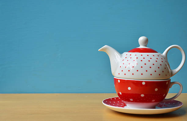 istock Red polka dot kettle on wooden 461179651